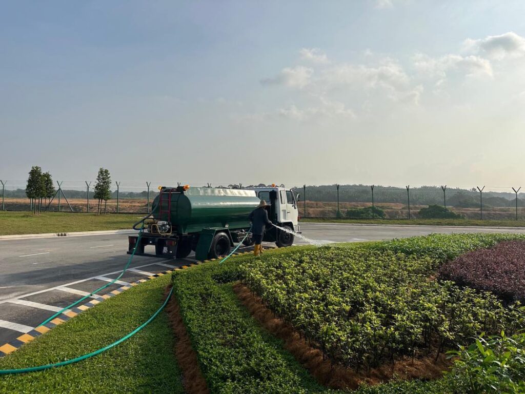 Worker maintaining Senai Airport roundabout